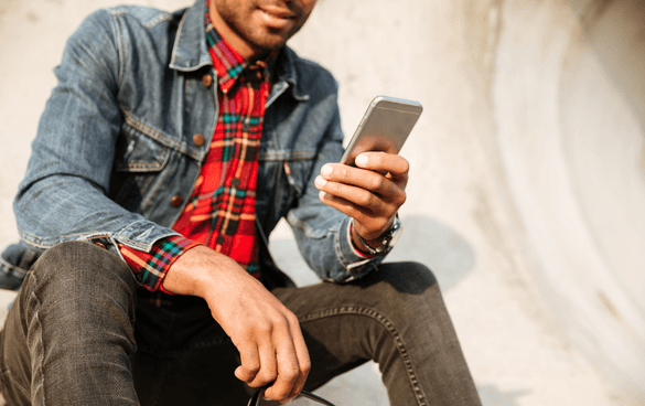 guy holding phone; how to set up a tiktok shop